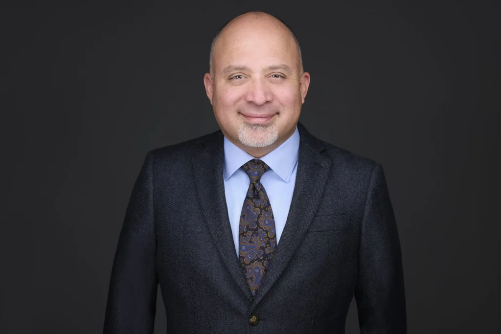 Dr. Rafael Bustamante, general dentist, in a suit and tie